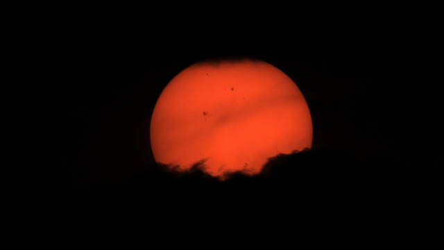 Red glowing star with shadows of clouds