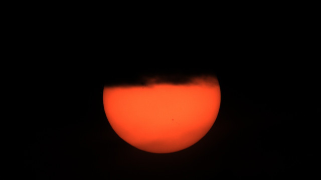 Cloud silhouet on top of the sun