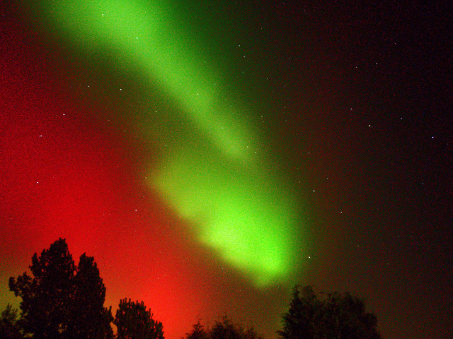Bright red and green aurora over Bavaria, Germany