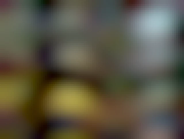 the sun is setting behind a magnificent oak, its large and generous limbs dark, twisting in all directions. there is a patch of new grass brilliantly illuminated in the distance.