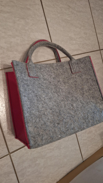 Grey felt handbag on the floor. No sign of a cat.