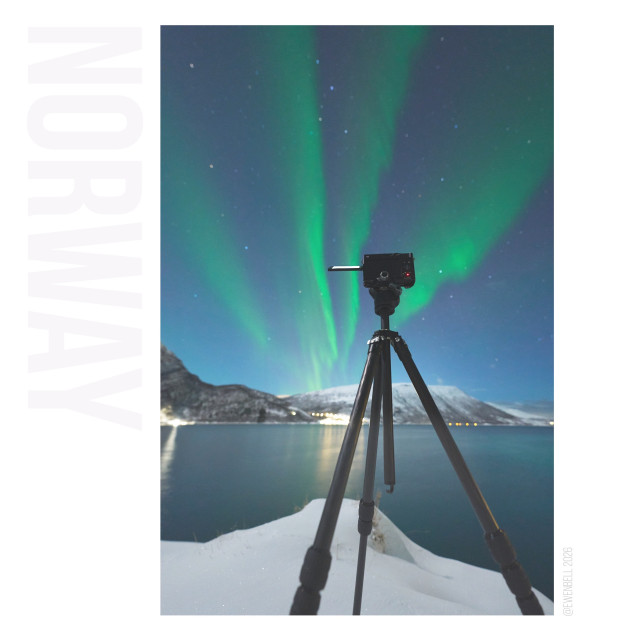 My camera on a tripod, taking a time-lapse, while the auroras are dancing across the fjord.