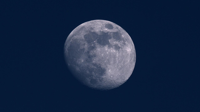A detailed image of the moon against a dark sky, showing its cratered surface and phases.