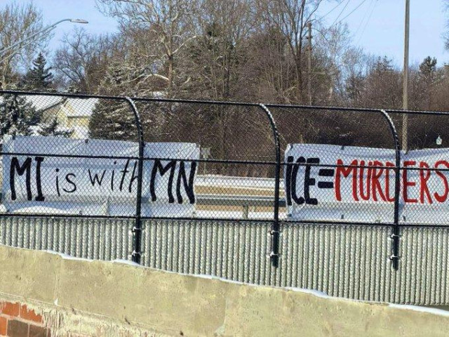 Two large white banners attached to a walkway in Michigan read

MI IS WITH MI

ICE = MURDERS