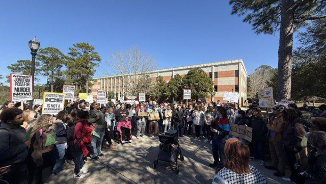 Students with placards march on campus