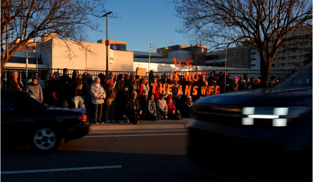 Outside a hospital in Augusta, people hold large red letters reading ICE IS NOT THE ANSWER