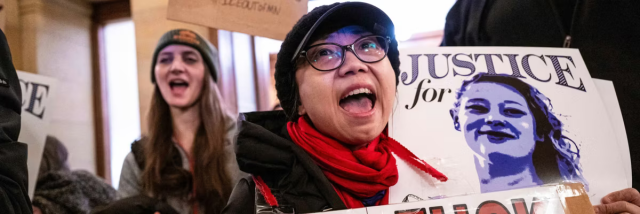 Protesters with placards outside Tim Walz's office