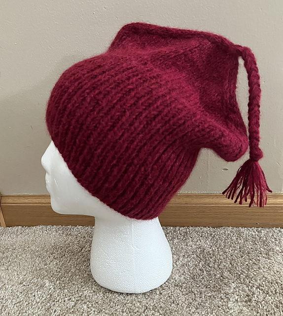 A red knitted hat with a tassel