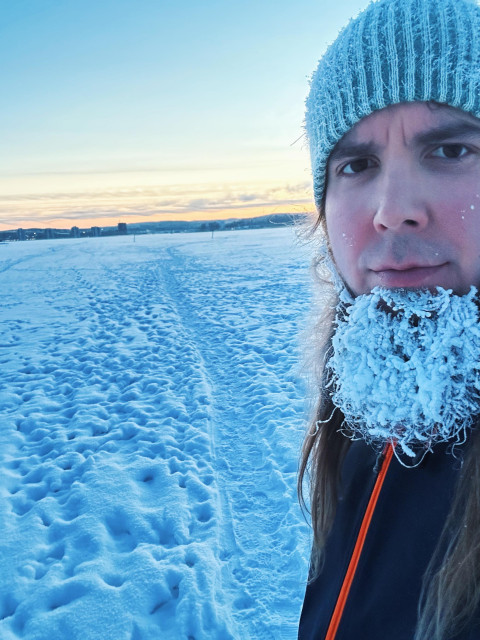 Me on ice, frozen beard, looking at the camera, sun is setting