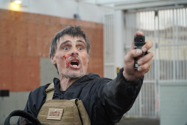 Bloodied far right asshole pointing his mace at people 