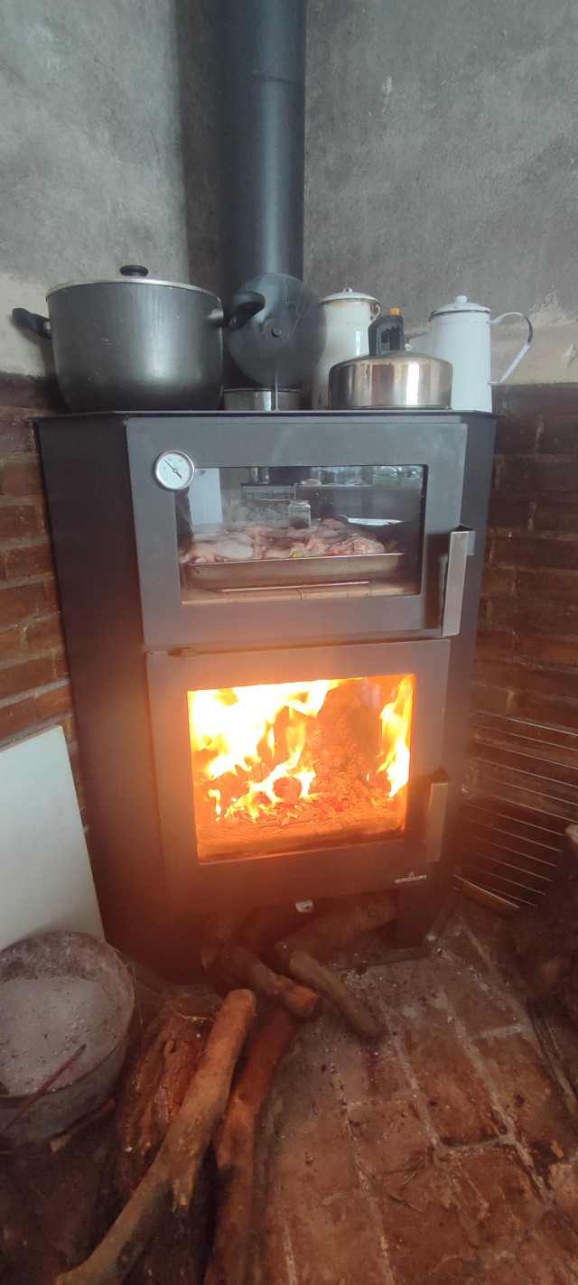 wood stove roaring with roast chicken dinner in the oven