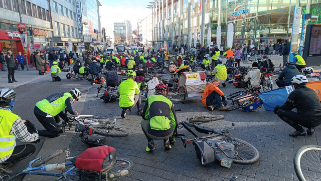 Photo taken today shows a group of some hundred bicycles laid down on a shopping street.