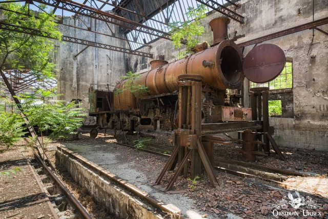 rusted steam train in workshop
