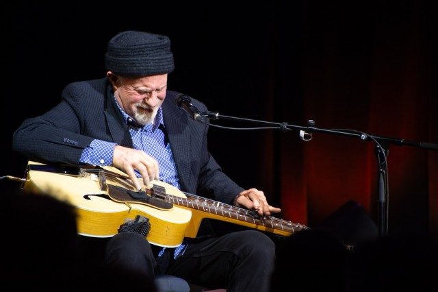 Harry smiles as he digs into a slide part. 