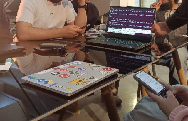 A laptop on a table, displaying a command line interface for installing a DeltaChat server.
