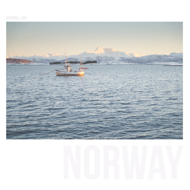 Wider shot of the scene, with the fishing boat pushed to the back of the frame.