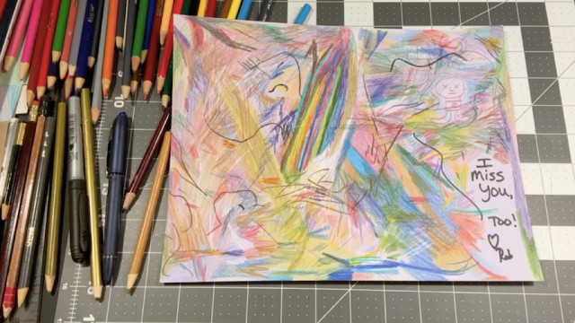 Multicolor abstract pencil scribble drawing on card stock with, "I miss you, too! Love, Rob" written in black marker.