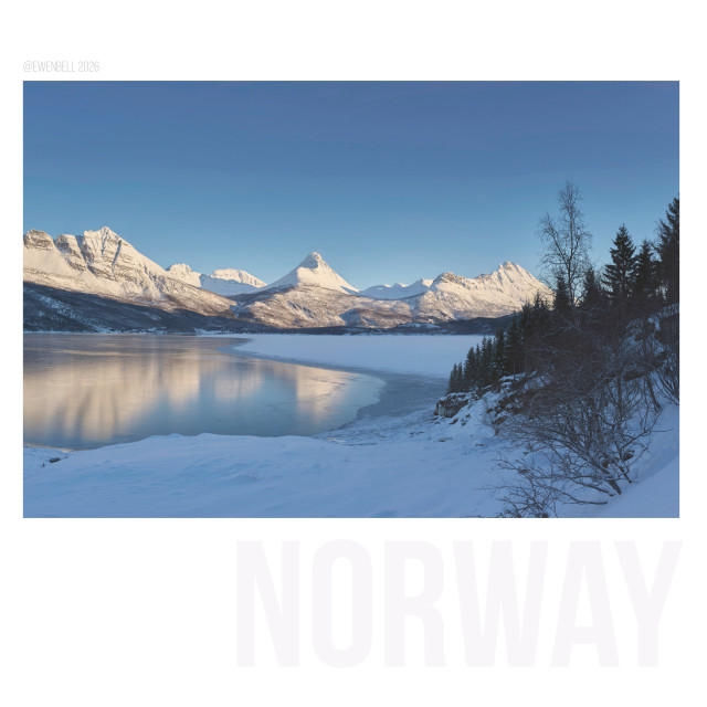View across Grovfjord with the mountain reflecting in the shallow ice.