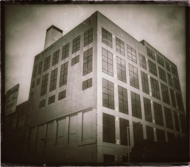 A scratchy picture of a very bulky, 10-story concrete building with a large ventilation stack on the roof. Lights of the building are punctuated with large paned windows... but many of these windows used to be open cubby holes housing large tanks of fermenting beer.

Alas, the beer is gone. So too is the large Hamm's sign and giant glass of beer on the roof that used to promise drunken pleasure to all passing cars on the neighboring elevated freeway.