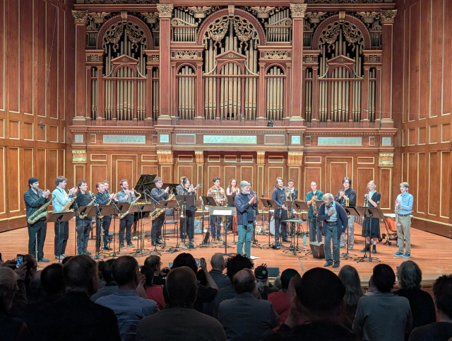 Anthony Braxton joins the NEC Orchestra for a curtain call and takes a bow on stage with organ pipes in view
