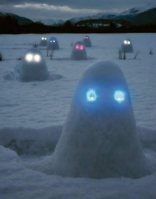 Snow monsters with glow sticks for eyes.