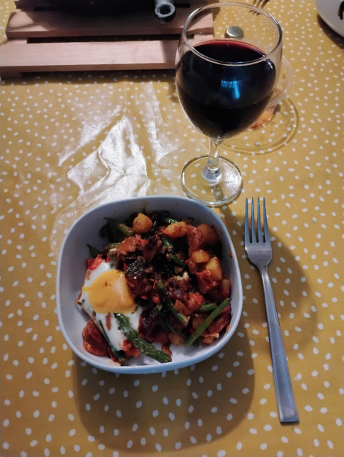 Bowl of the afore mentioned next to a glass of red wine.