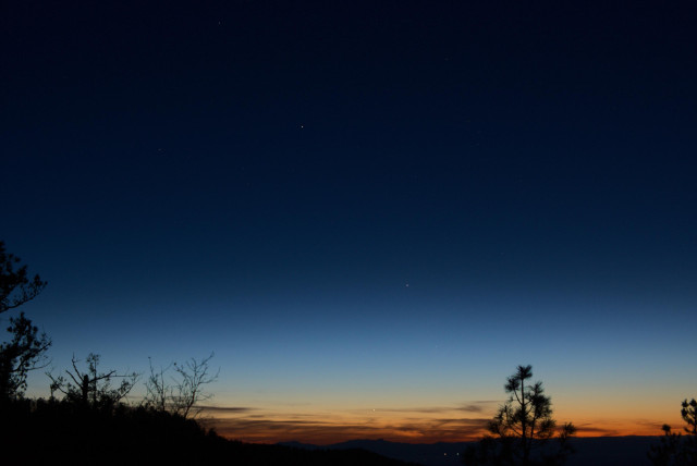 Evening twilight shows us a great range of brightness and color in the sky.

Distant cirrus clouds are very low to the horizon, and Venus is nestled in a narrow horizontal band of cloud.

Mercury is slightly below center and Saturn is above center and to the left of center.

A few stars of Pisces and Cetus are also in the photo.
