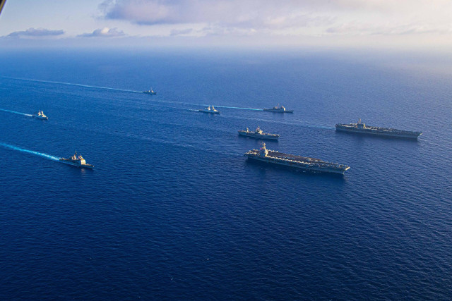 The USS Dwight D. Eisenhower and USS Gerald R. Ford carrier strike groups flank USS Mount Whitney, in the Mediterranean Sea, November 2023.
