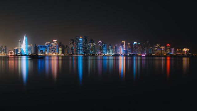 A city skyline of Doha at night, long-term exposure.