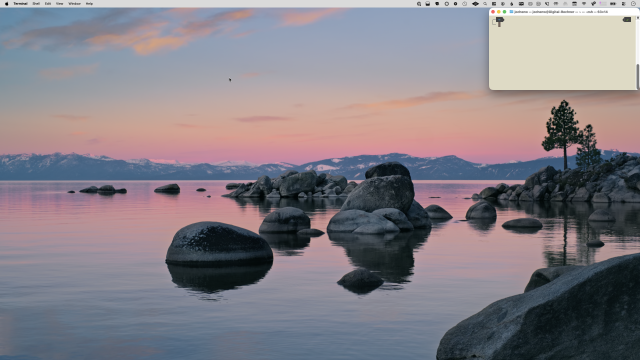 Full screen view of a macOS 26 Tahoe desktop. A lonesome Terminal window is tucked into the top-right corner.