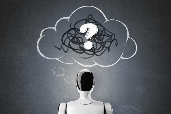 “Humanoid robot with a glossy black face and white body standing in front of a chalkboard, looking up at a large thought cloud containing a messy scribble and a question mark, symbolizing confusion or uncertainty about artificial intelligence or thinking robots.”