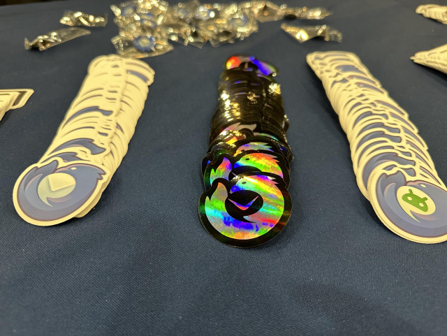 A collection of Thunderbird stickers on a blue tablecloth