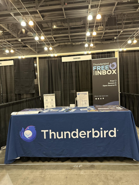 The Thunderbird booth, with a Thunderbird tablecloth and a pop-up banner saying 'Free the Inbox,' just waiting for visitors!