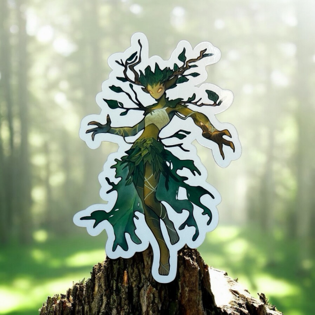 Fantasy forest dryad sticker with glowing golden eyes, antler-like branches, and a body formed from leaves and vines. The figure stands on a tree stump with a soft green woodland background, giving the impression of a guardian of the forest.