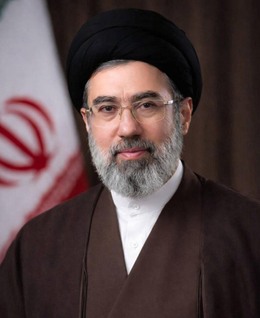 Photograph of Mojtaba Khamenei with Iranian flag in the background