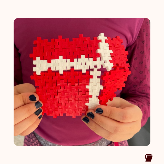 Someone holding the Tuta logo made out of Plus Plus toys. 