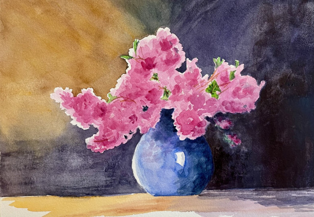 A vibrant bouquet of pink blossoms spills from a round blue vase, their soft petals glowing against a dramatic wash of warm gold and deep shadow in the background.