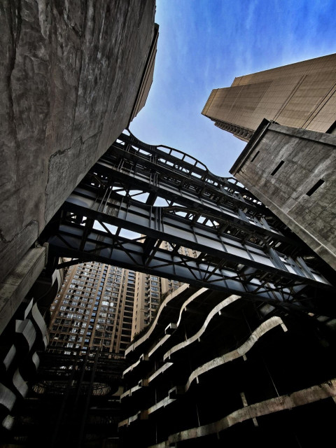 Looking up through an enormous concrete structure.