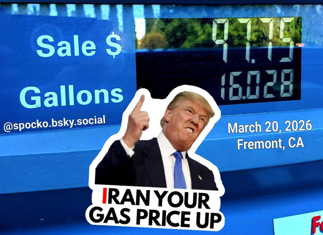 The car owner paid $6.09 a gallon for regular gas, total:
$97.75 for 16 gallons
Sticker of Trump pointing to the price saying 
Iran your gas price up. 
@spocko@mastodon.online 

I took this photo at 11 am,
March 20, 2026 in Fremont, CA