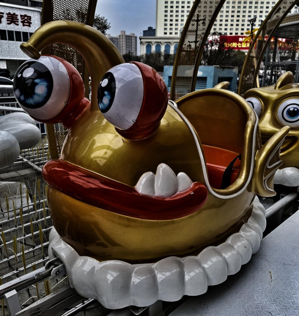 A bug-eyed, golden roller coaster car.