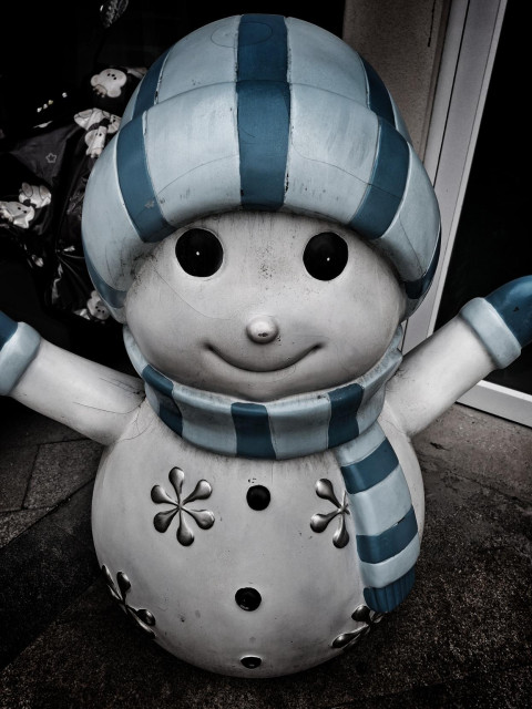 Evil looking snowman plastic statue