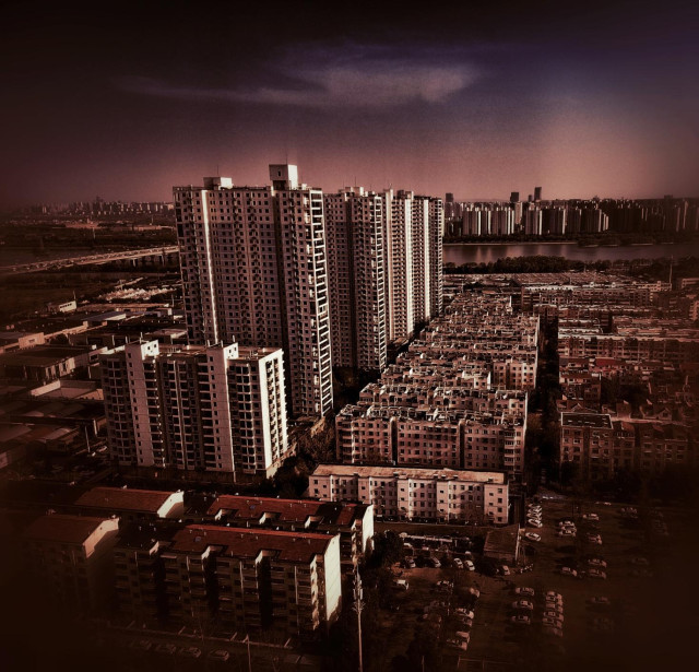 Luoyang city skyline under redish purple sky.