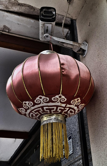 Chinese lantern hanging from a surveillance camera