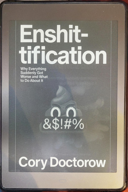 Picture of Cory Doctorow's book Enshittification frontpage as ebook on an ereader.