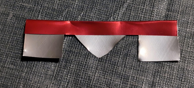 The "M" shaped rectangle of soda can, with the top folded down.