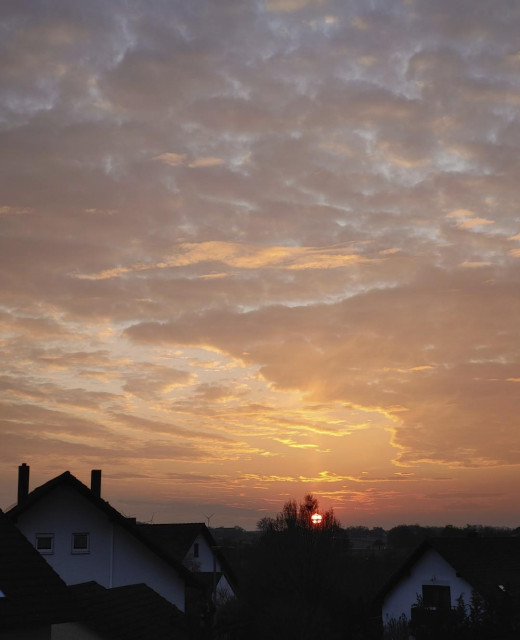 Series of four images in chronological order. 1: Sun just before setting. Creating a golden ceilibg of clouds looking like an oil painting. No pillar visible