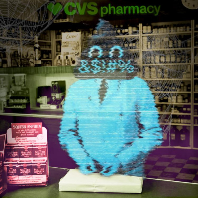 A 1950's pharmacy with a labcoated pharmacist behind the counter. The pharmacist's head has been replaced with the poop emoji from the cover of 'Enshittification,' its mouth covered with a black bar scrawled with grawlix. The pharmacy has been made over to look haunted, with purple mist rising from the ground and cobwebs in the top corners. A CVS Pharmacy sign hangs in the background.