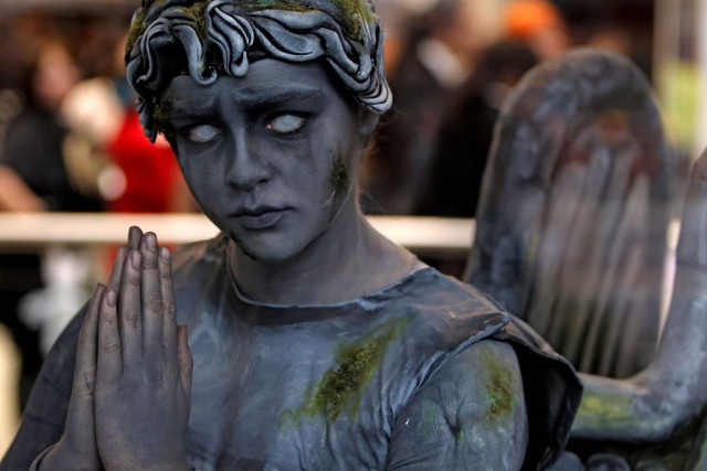 A person dressed as a Weeping Angel from Doctor Who.