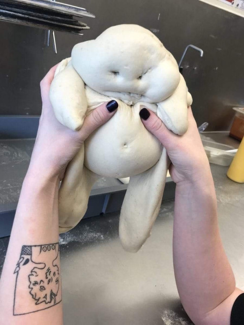 plimbo. dough baby held by pale hands 