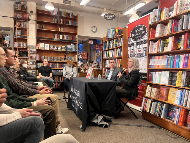 Cindy Cohn speaks into a mic next to Jonathan Zittrain at the Harvard Book Store.